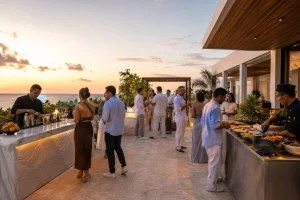 Guests enjoying cocktails and small plates during a sunset cocktail party in Cancun