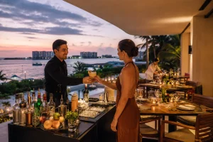 Private Bartender Cancun preparing drinks from a full mobile bar with ice, spirits and fresh ingredients