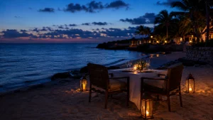 Private beach dinner for two with candles beside the Caribbean at sunset