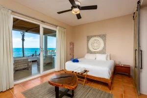 Ocean-view bedroom at a private beachfront villa in Riviera Maya with direct access to the terrace