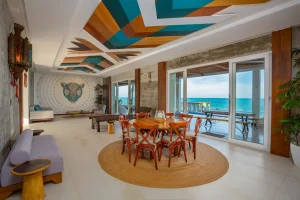 Open-plan dining and living area inside a Riviera Maya beachfront villa overlooking the Caribbean