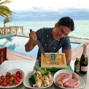 Riviera Maya Private Chef preparing ingredients for a private meal beside a beachfront villa pool