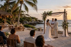 Friends and family sharing a candlelit seaside dinner during a Cancun wedding celebration