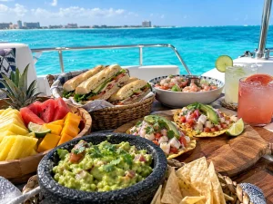 Fresh yacht food in Cancun with ceviche, guacamole, fruit, sandwiches and tostadas served on the Caribbean Sea