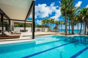 Outdoor dining table beside a private villa pool in Playa del Carmen